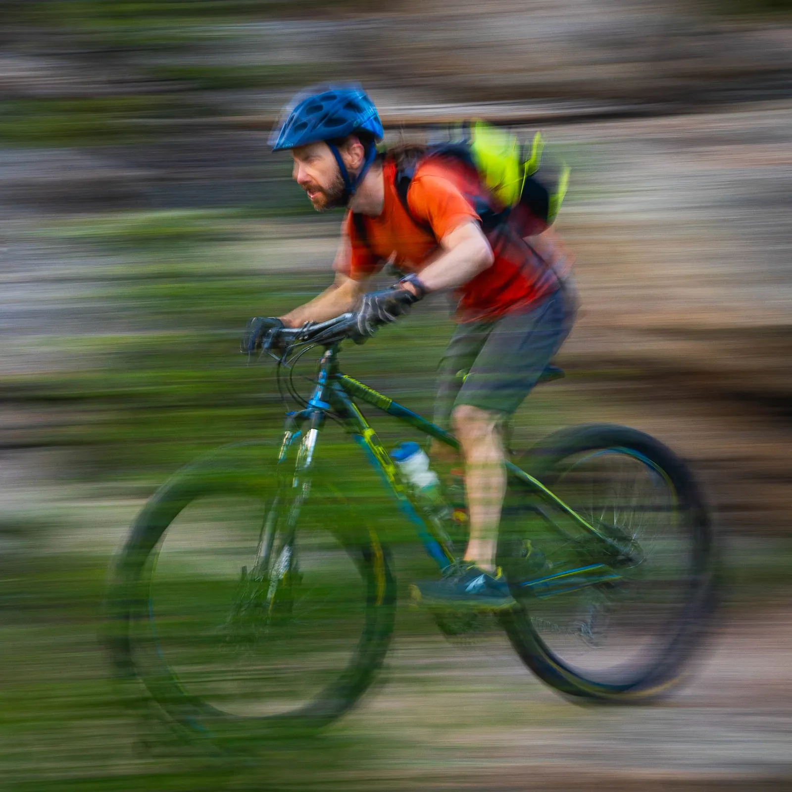 A cyclist moving quickly through the trees